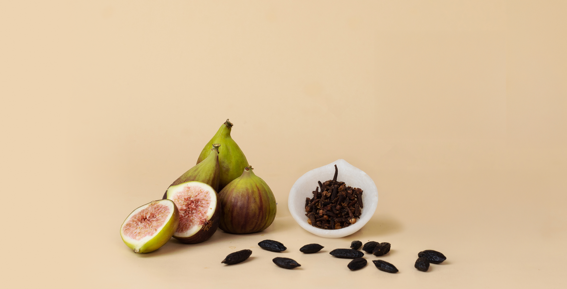 Figs cut open on beige background